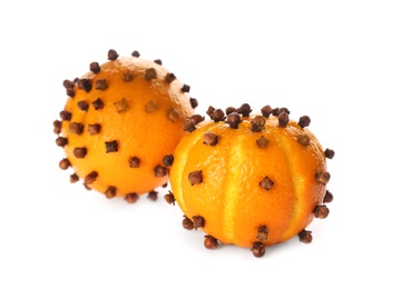 Pomander balls made of fresh tangerines and cloves on white background