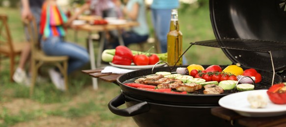 Modern grill with meat and vegetables outdoors, closeup. Banner design