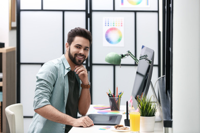 Male designer working at desk in office