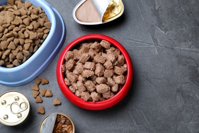 Wet and dry pet food on grey table, flat lay. Space for text