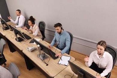 Call center operators working in modern office, above view