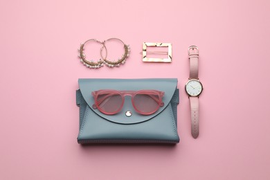 Stylish woman's bag and accessories on pink background, flat lay