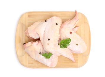 Raw chicken wings with spices and parsley on white background, top view