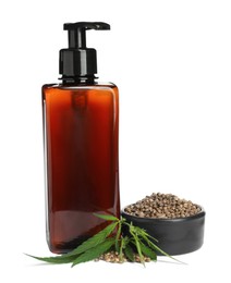 Bottle of hemp cosmetics with green leaves and seeds isolated on white