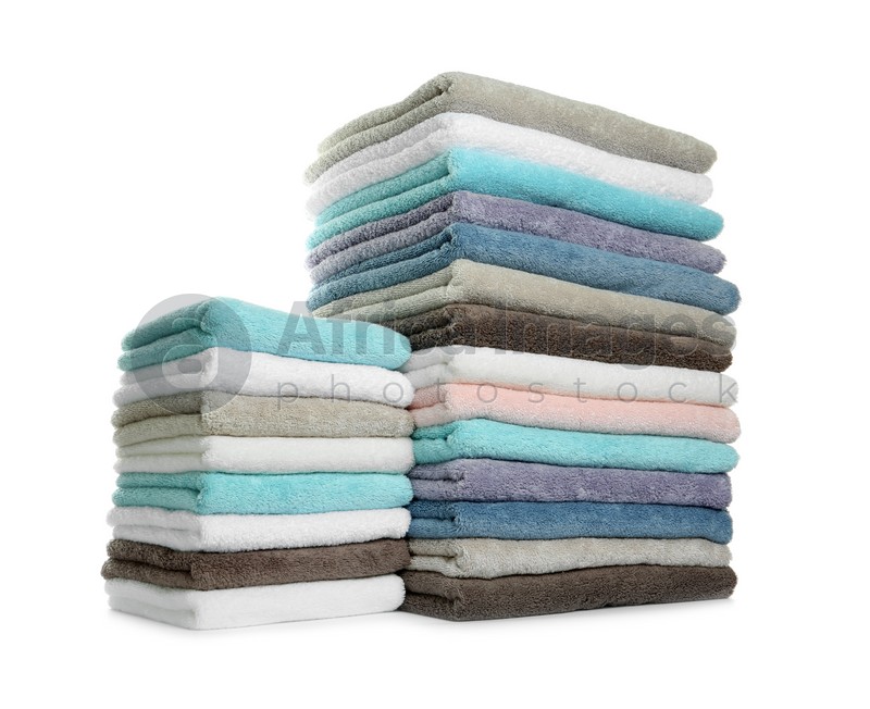 Different fresh soft terry towels on white background