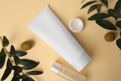 Photo of Different cosmetic products and ingredient on beige background, flat lay