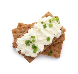 Photo of Crispy crackers with cottage cheese and green onion on white background, top view