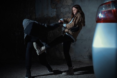 Photo of Woman defending herself from attacker on parking lot