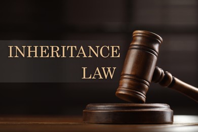 Phrase Inheritance law and wooden gavel on table against blurred background, closeup