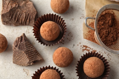 Flat lay composition with tasty raw chocolate truffles on light background