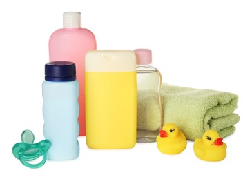 Photo of Bottles of baby cosmetic products, towel, pacifier and rubber ducks on white background