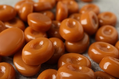 Tasty hard toffee candies on table, closeup