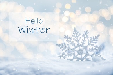 Hello Winter. Beautiful decorative snowflake in white snow, bokeh effect 