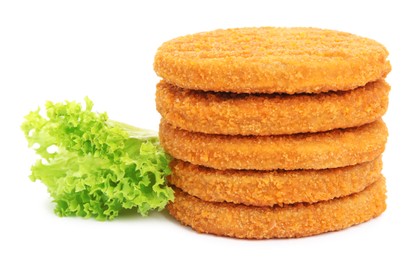 Photo of Uncooked breaded cutlets, tomato and lettuce on white background. Freshly frozen semi-finished product