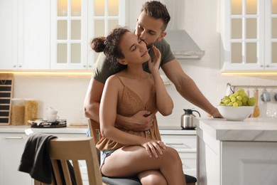 Lovely couple enjoying time together in kitchen at home