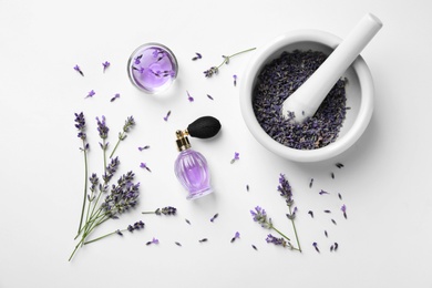 Photo of Composition with natural perfume and lavender flowers on white background, top view. Cosmetic product