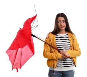 Emotional woman with umbrella broken by gust of wind on white background
