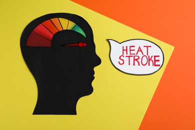 Human head cutout with temperature conversion chart and words Heat Stroke on color background, flat lay