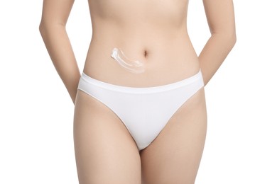 Photo of Young woman with body cream smear on belly against white background, closeup