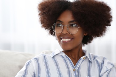 Photo of Portrait of smiling African American woman wearing glasses at home
