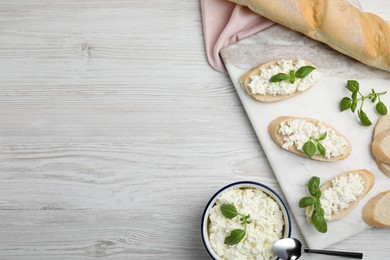 Photo of Bread with cottage cheese and basil on white wooden table, flat lay. Space for text