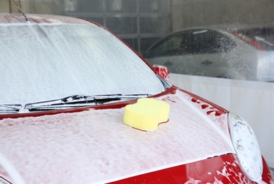 Automobile with sponge on its bonnet at car wash