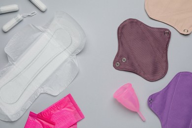 Different menstrual hygiene products on grey background, flat lay