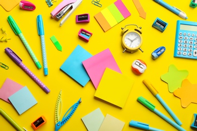 School stationery on yellow background, flat lay. Back to school