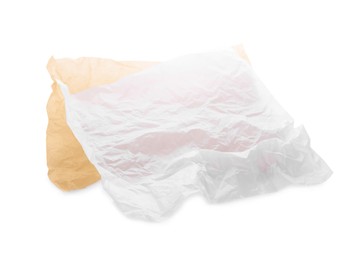Sheets of crumpled baking paper on white background