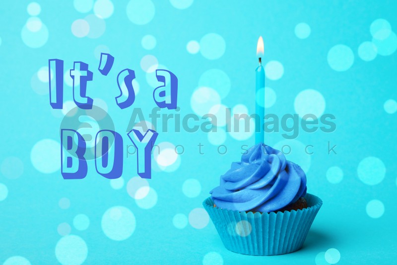 Image of Baby shower cupcake with candle for boy on light blue background