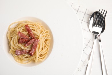Delicious Carbonara pasta served on white wooden table, flat lay