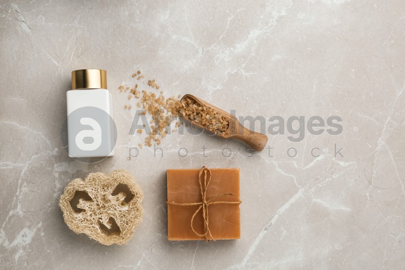 Flat lay composition with spa supplies on stone table