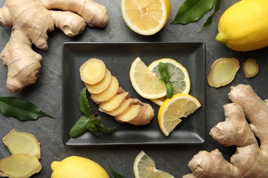 Photo of Fresh lemons, ginger and mint on grey table, flat lay