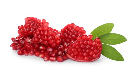 Pieces of tasty ripe pomegranate and leaves on white background