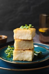 Delicious turnip cake with microgreens served on black table