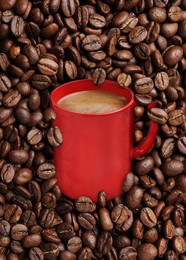 Image of Cup of tasty americano and roasted coffee beans