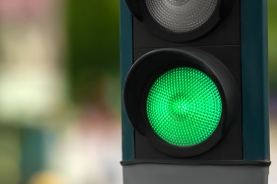 Traffic light on blurred background, closeup. Space for text