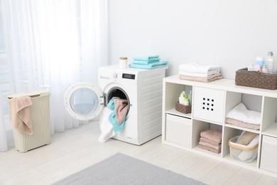 Bathroom interior with towels and washing machine