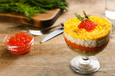 Photo of Traditional russian salad Mimosa served on wooden table, space for text
