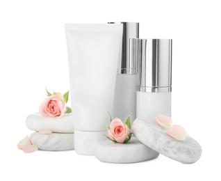 Cosmetic products, spa stones and flowers on white background