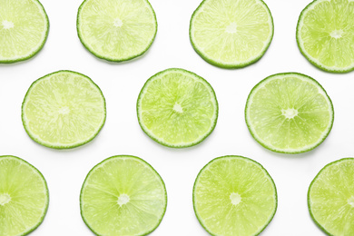 Fresh juicy lime slices on white background, top view