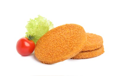 Uncooked breaded cutlets, tomato and lettuce on white background. Freshly frozen semi-finished product