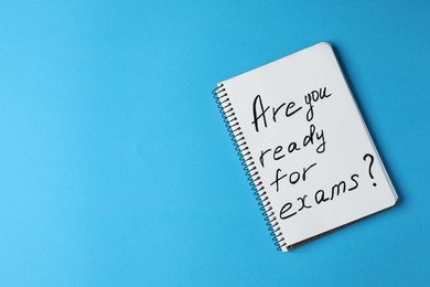 Notebook with phrase Are You Ready For Exams on turquoise background, top view. Space for text