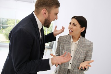 Man screaming at woman in office. Toxic work environment