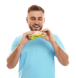 Photo of Young man eating tasty sandwich on white background