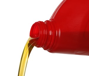 Pouring motor oil from red container isolated on white