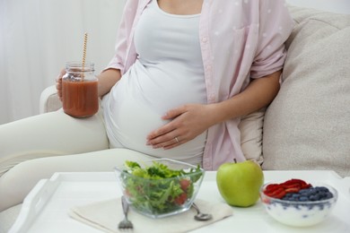 Pregnant woman eating breakfast at home, closeup. Healthy diet