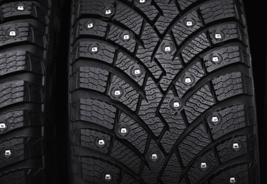 Car tires as background, closeup. Auto store
