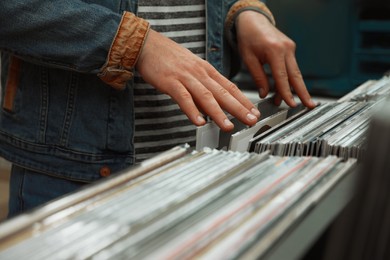 Man choosing vinyl records in store, closeup