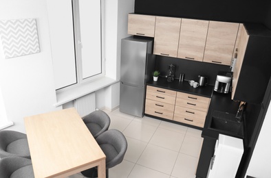 Cozy modern kitchen interior with new furniture and appliances